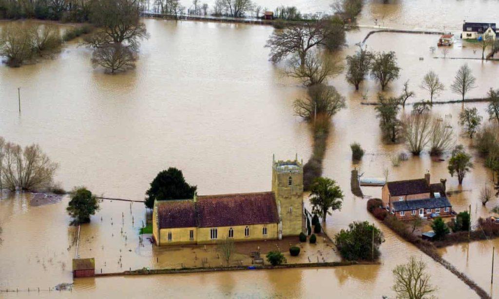 Flood water surrounds St Michael and All Angels church in Tirley, Gloucestershire. Photograph: Steve Parsons/PA